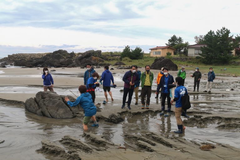 海岸で解説をする様子